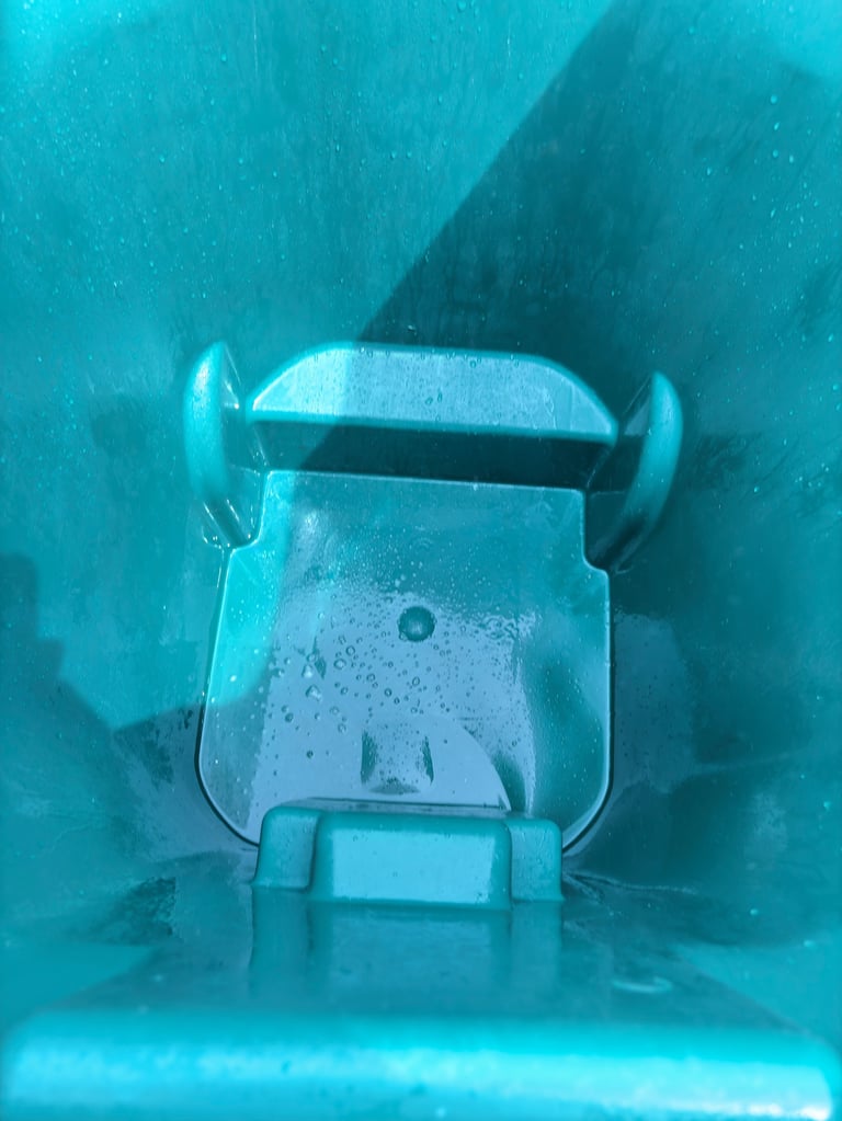 Underwater robot or submersible with arms viewed from above in turquoise water